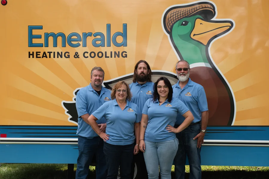 Emerald team photo smiling in front of truck with Emerald logo