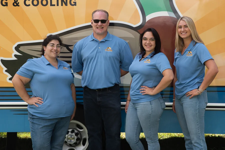 Heating and cooling experts from Erie County, NY, standing proudly by Emerald's recognizable branded service van