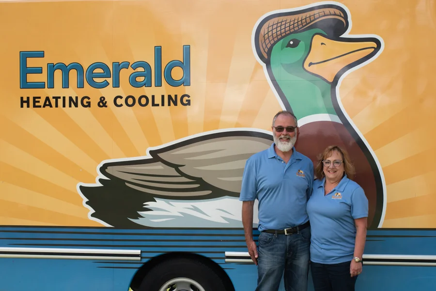 Proud owners of Emerald Heating & Cooling beside the branded service van, committed to comfort in Western New York.