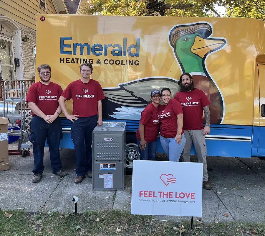 Emerald's Feel the Love team with a donated Lennox furnace outside a Western New York home after a free installation