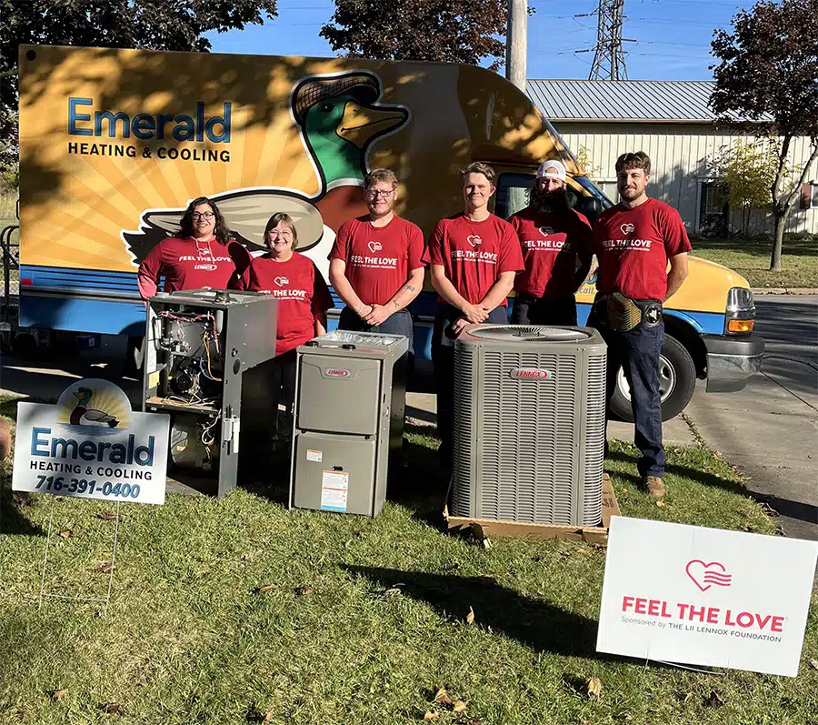 Warm smiles after a free Lennox furnace install in Western NY — Emerald's Feel the Love team celebrates giving back.