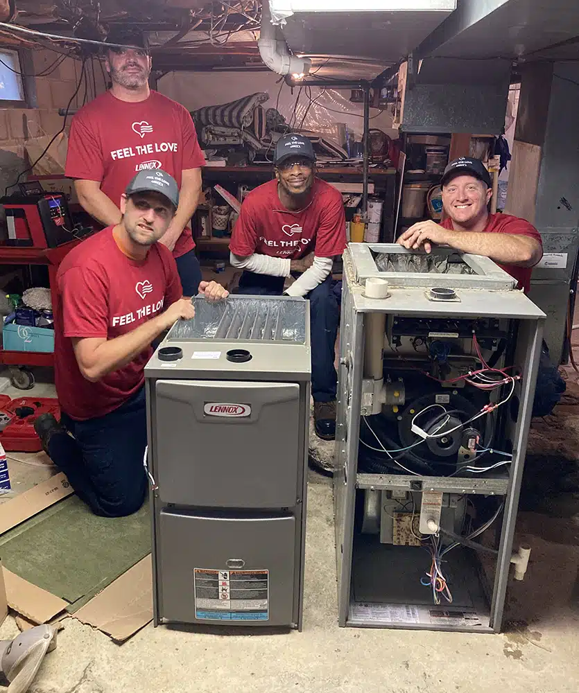 Emerald Feel the Love team smiling beside a new Lennox furnace at a Depew NY home