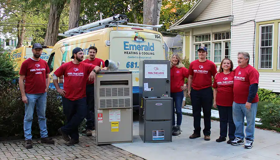 A full Feel the Love crew in Erie County, NY, with the old and new Lennox furnaces outside a Western New York home.