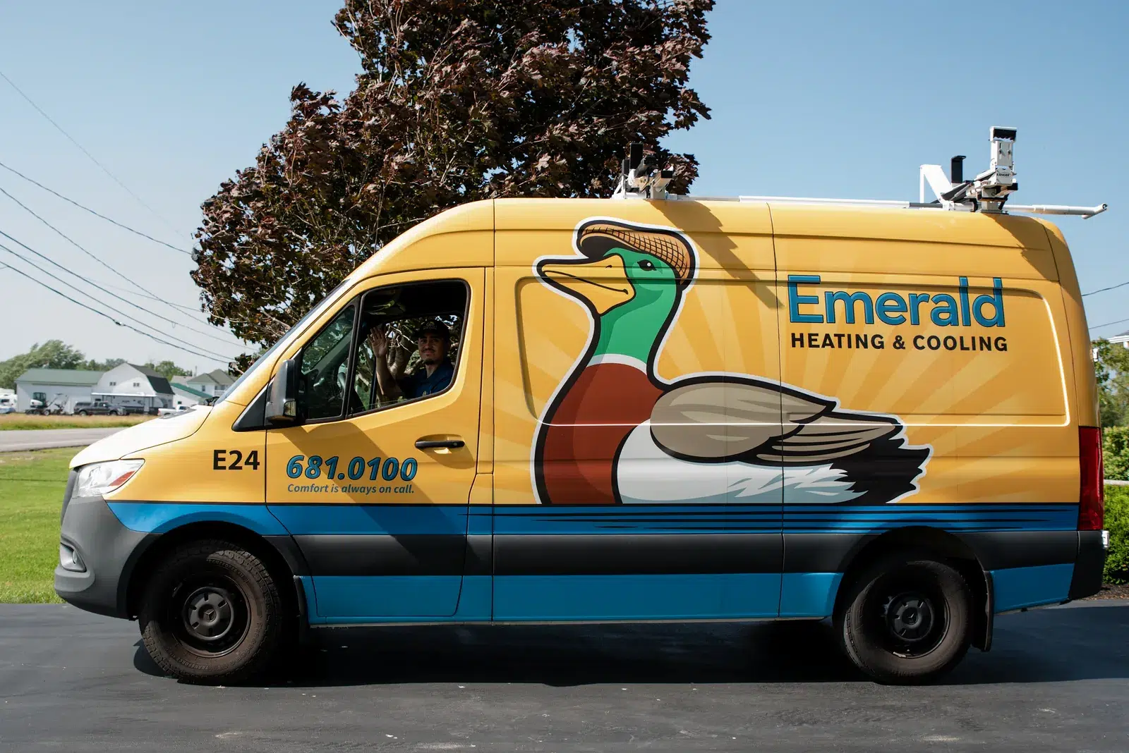 An Emerald Heating & Cooling branded service van parked outside the Depew, NY shop