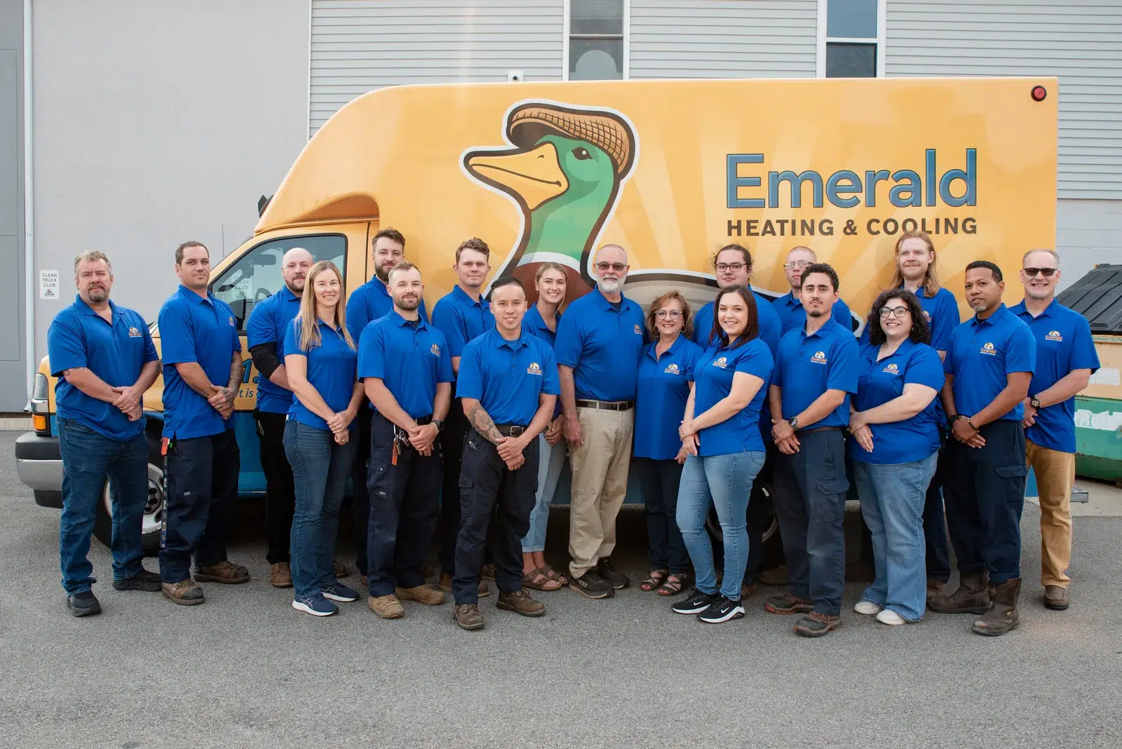 The Emerald Heating & Cooling staff lined up beside a branded service van at the Depew, NY shop