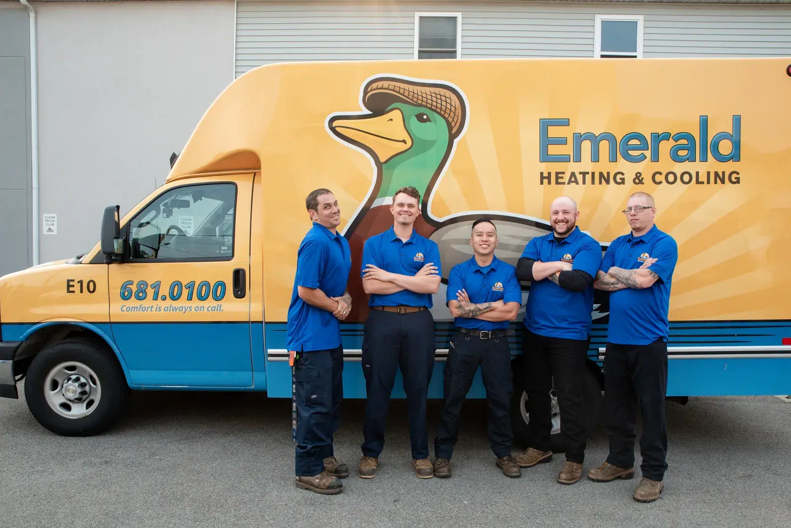 Emerald Heating & Cooling field technicians beside a branded service van in Depew, NY