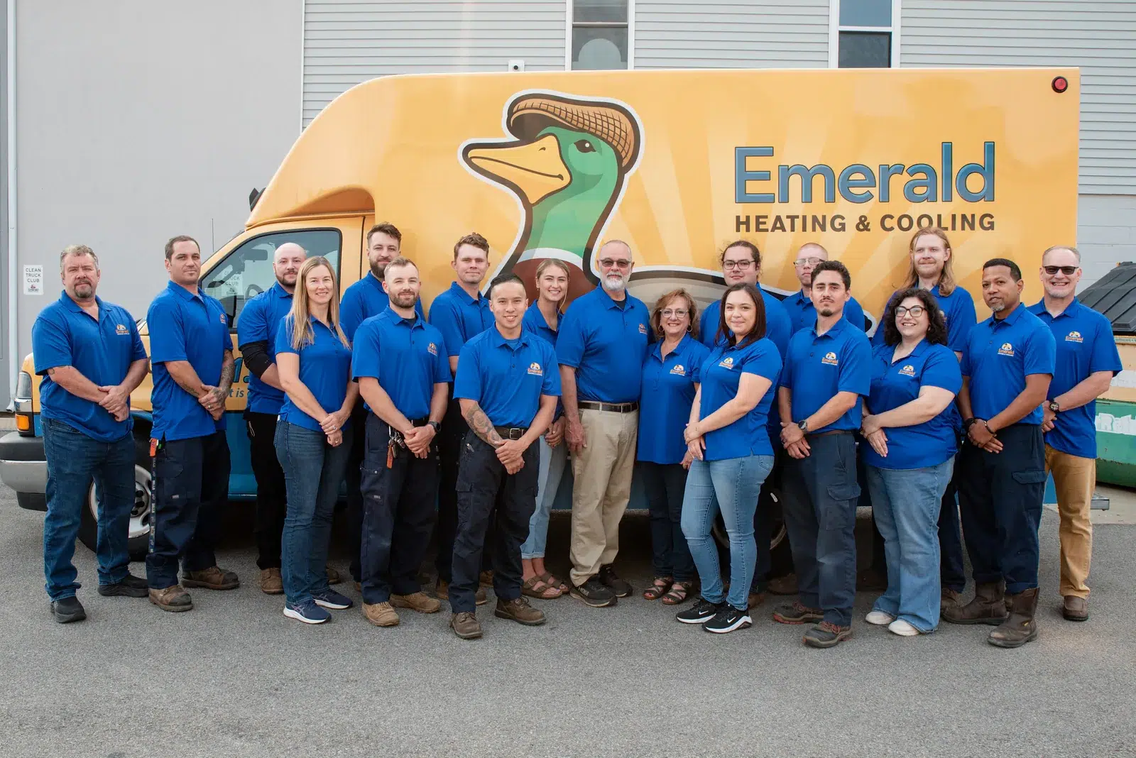 The full Emerald Heating & Cooling team gathered beside a branded service van in Depew, NY