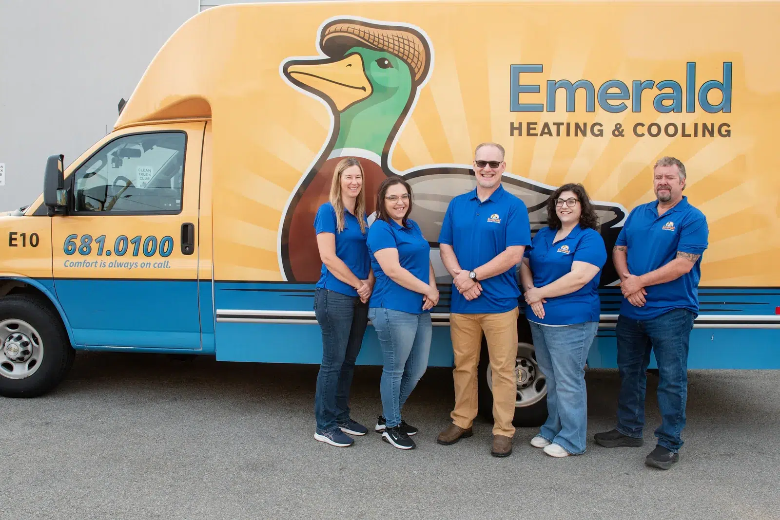 Emerald Heating & Cooling office staff standing in front of a branded service van in Depew, NY