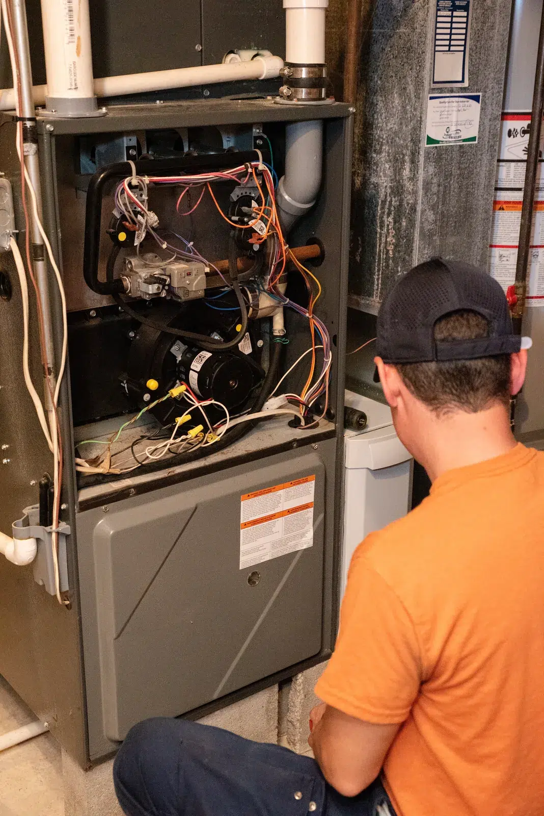 Emerald technician performing annual maintenance on a gas furnace in a Depew, NY basement