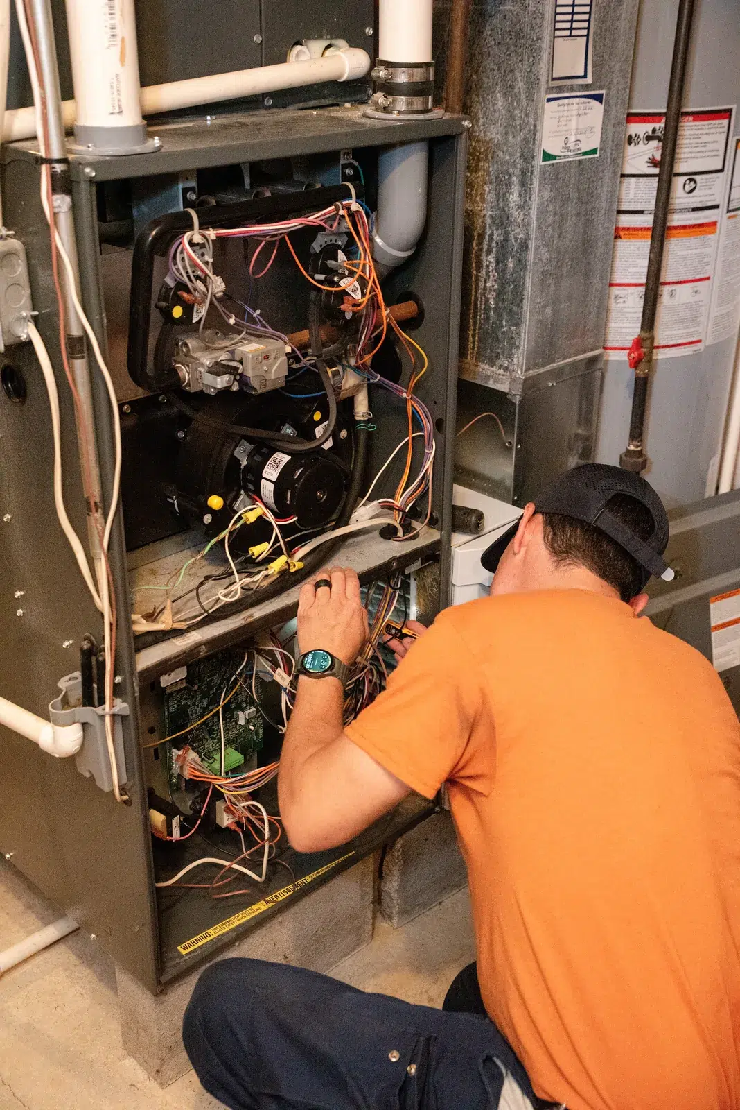 Emerald technician testing the control board inside an open gas furnace